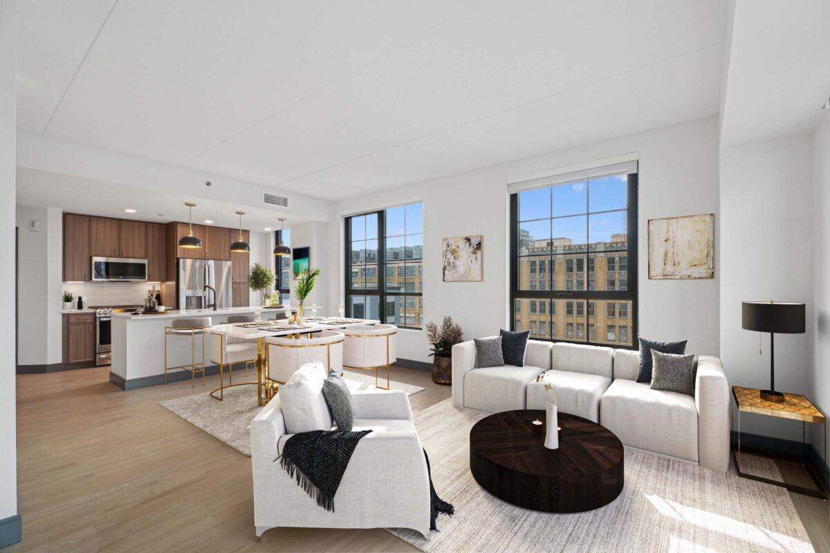 Bright living and dining area with white sofas and panoramic windows.