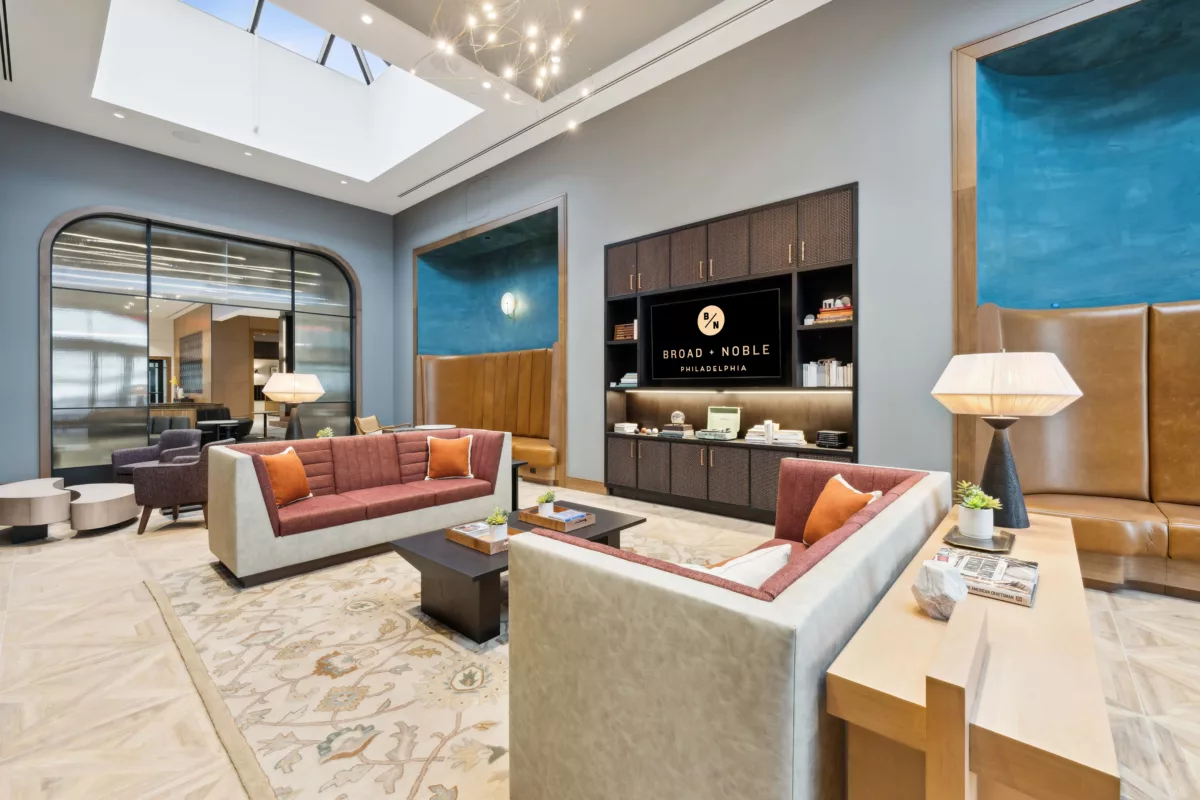 Lobby with TV screen and seating on couches and chairs