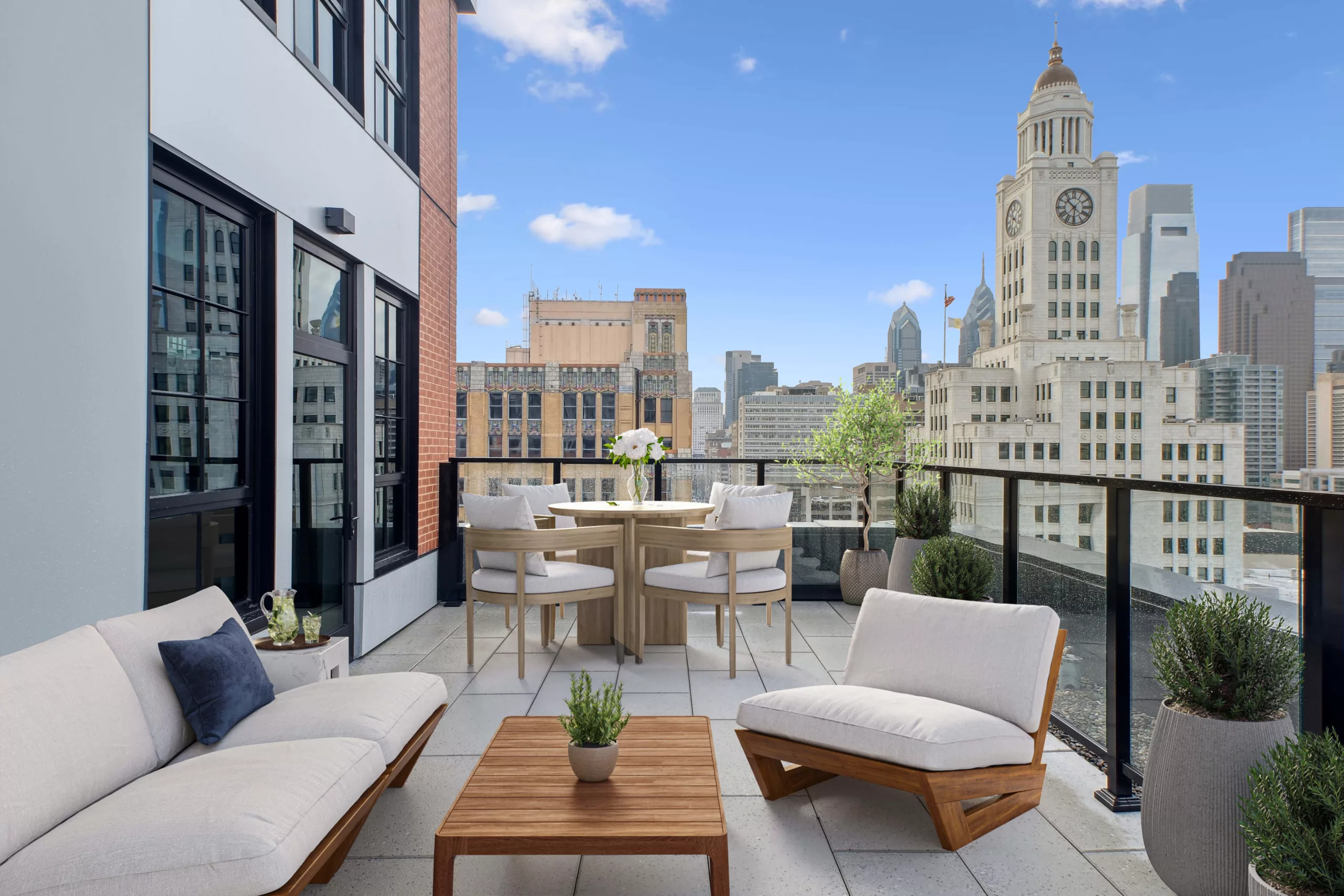 Rooftop terrace with cushioned seating and city skyline in background.